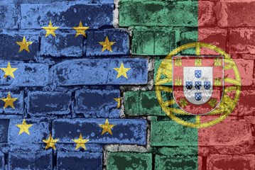 The flag of the European Union and Portugal on a brick wall