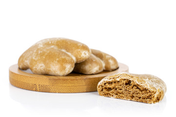 Group of two whole one half of sweet brown gingerbread on bamboo coaster isolated on white background