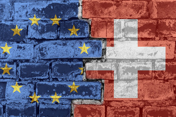The flag of the European Union and Switzerland on a brick wall