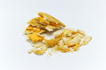Biscuit and crumbs of sandwich cracker Cheese flavoured ,Cream and butter. Crunchy delicious sweet meal and useful cookies. On white background. Selective focus.