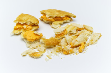 Biscuit and crumbs of sandwich cracker Cheese flavoured ,Cream and butter. Crunchy delicious sweet meal and useful cookies. On white background. Selective focus.