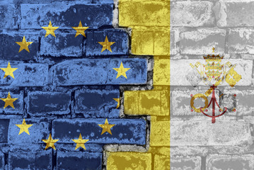 The flag of the European Union and the Vatican on a brick wall