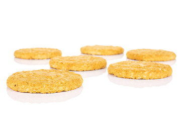 Group of six whole sweet golden oat cookie isolated on white background