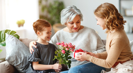 mother's day! three generations of  family mother, grandmother and daughter congratulate on the...