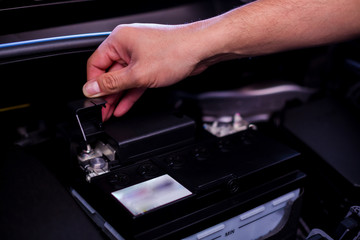 Check and maintenance the battery in car with yourself. Service and maintenance car or vehicle. Hand checking battery of car.