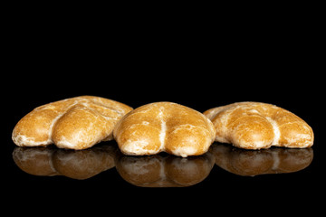 Group of three whole sweet brown gingerbread isolated on black glass