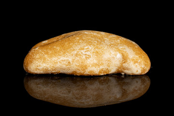 One whole sweet brown gingerbread isolated on black glass