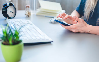 girl working through a smartphone from home