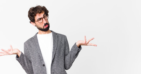 young crazy businessman shrugging with a dumb, crazy, confused, puzzled expression, feeling annoyed...