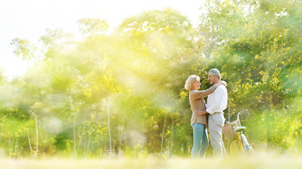 Caucasian elderly couples come to relax in the park during the summer. Of long holidays and Picnic. Tourism activities Of retire. Friendship, love and care your health. Health insurance concept