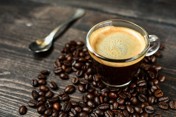 Coffee cup espresso and beans on a wooden background. breakfast concept, italian coffee