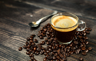 Coffee cup espresso and beans on a wooden background. breakfast concept, italian coffee