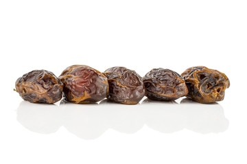 Group of five whole dry brown date fruit isolated on white background