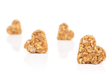 Group of four whole healthy brown cereal heart with cocoa isolated on white background