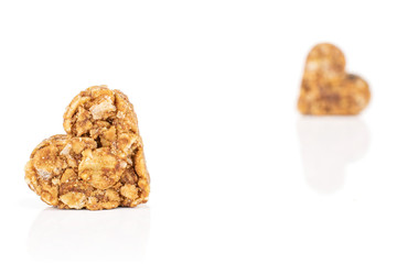 Group of two whole healthy brown cereal heart with cocoa isolated on white background