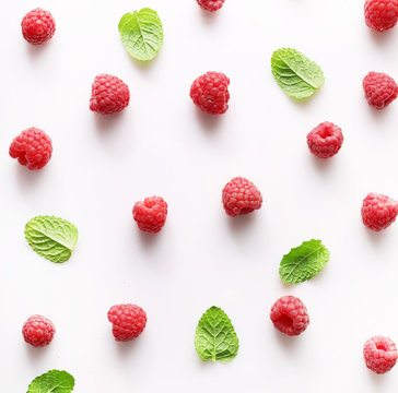 Texture of red ripe raspberries on white background