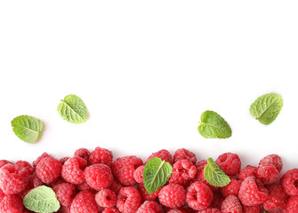 Border of red raspberries isolated on white background