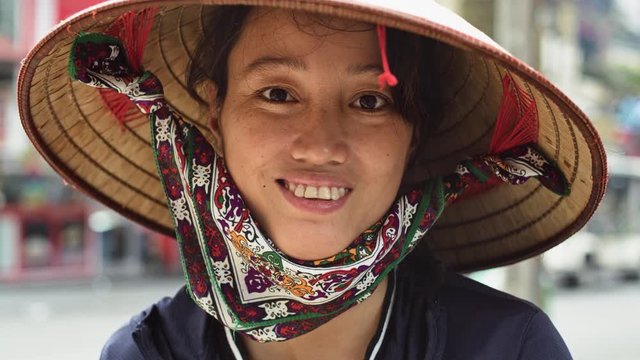 Handheld video shows of Vietnamese young woman smiling. Shot with RED helium camera in 8K