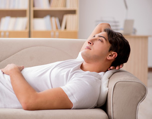 Young man sleeping in sofa couch