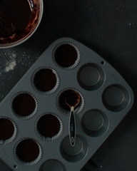 Cupcake pan filled with chocolate cake batter