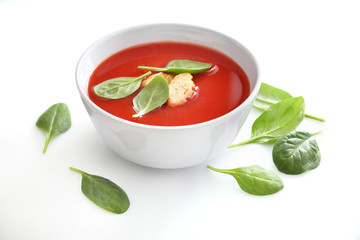 Bowl of tomato soup isolated on a white background