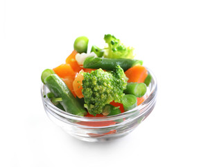 Frozen vegetables in bowl isolated on white background