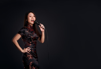 Korean girl with a microphone in hand sings in the studio