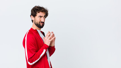 young bearded man back view scheming and conspiring, thinking devious tricks and cheats, cunning...