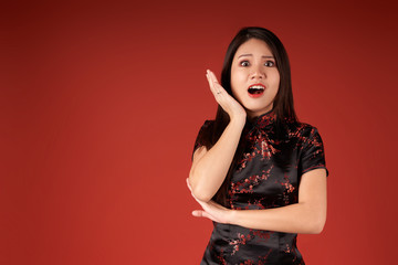 Korean emotional girl on a red background in the studio