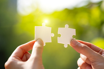 Hand holding jigsaws. Connection concept.