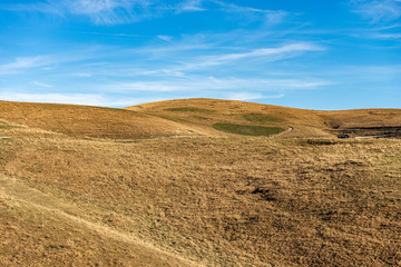 Fototapeta na wymiar Brown and green meadows in autumn. Lessinia plateau, Italian Alps, Regional Natural Park, Veneto, Verona province, Italy, Europe