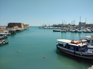 Fototapeta na wymiar Heraklion Harbour, Crete on a sunny day with boats moored in foreground