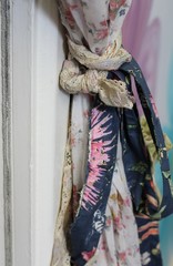 A door frame tie back of recycled fabrics, an interior design feature , shallow depth of field 