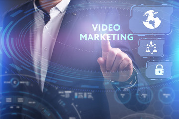 Business, Technology, Internet and network concept. Young businessman working on a virtual screen of the future and sees the inscription: Video marketing