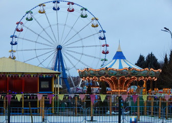 Attraction Ferris wheel and carousel in the amusement Park