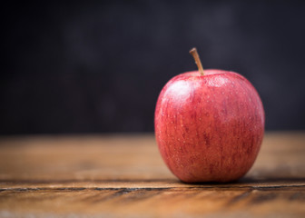 Room for text on the fruity background of a  small round apple waiting for the teacher