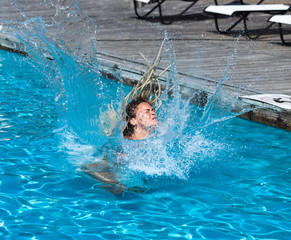 Naked woman with dreadlocks in swimming pool