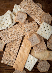 Close up of  assorted edible crackers in a a variety of shapes and textures as a flat lay