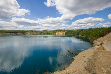 Flooded quarry lake with blue water landscape