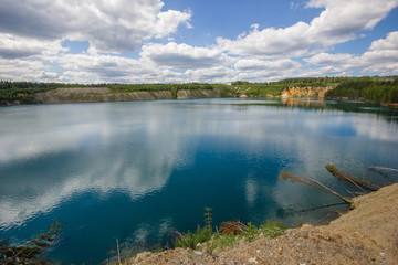 Flooded emerald quarry lake with blue water landscape