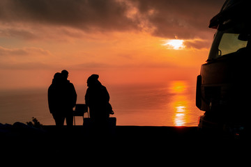 silhouette of a group of workers planning the day at sunset