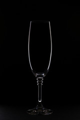 Glass of white wine on a black background with sparkling faces