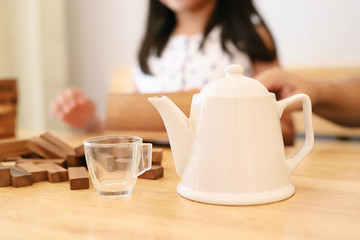 White teapot and clear glass tea