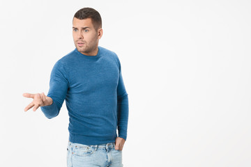 Unhappy young adult man asking what's the problem isolated on white background