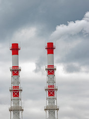 Stream of dark smoke from the chimney of factory in the industrial district. industrial smoke from...