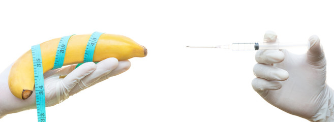 Health care, Hand holding banana and measuring tape with injection syringe isolated on white background. Increase penis size concept. surgery © jesada