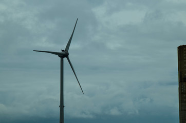 Fototapeta premium Oosterscheldekering, the netherlands, August 2019. In the Zeeland countryside, wind farms: a particular landscape characterized by wind turbines.