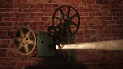Wide shot of a finished film reel with the film flapping after finishing playing on a vintage projector.