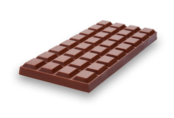 A perspective view of a bar of delicious and creamy milk chocolate, going slightly out of focus at the back, isolated on white