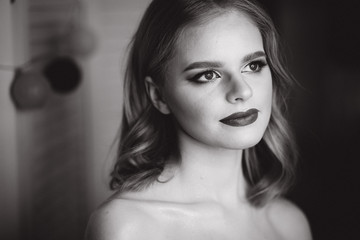 Naklejka premium Portrait of beautiful blond hair lady after makeup in beauty studio. Black and white photo. Ring lamp